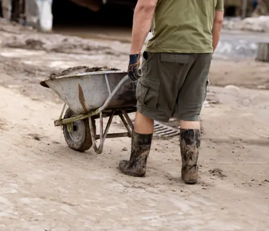 Freiwilliger Helfer mit Gummistiefel